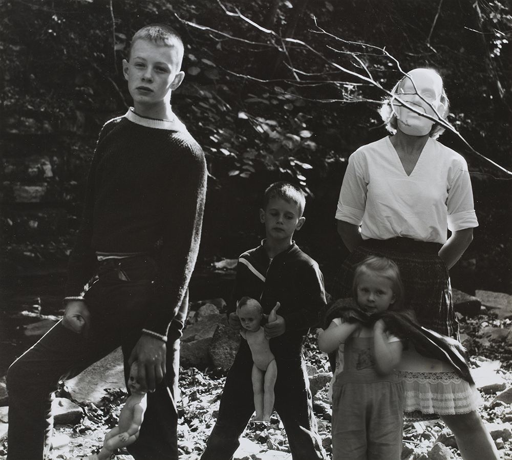 kids with mask and dolls in woods