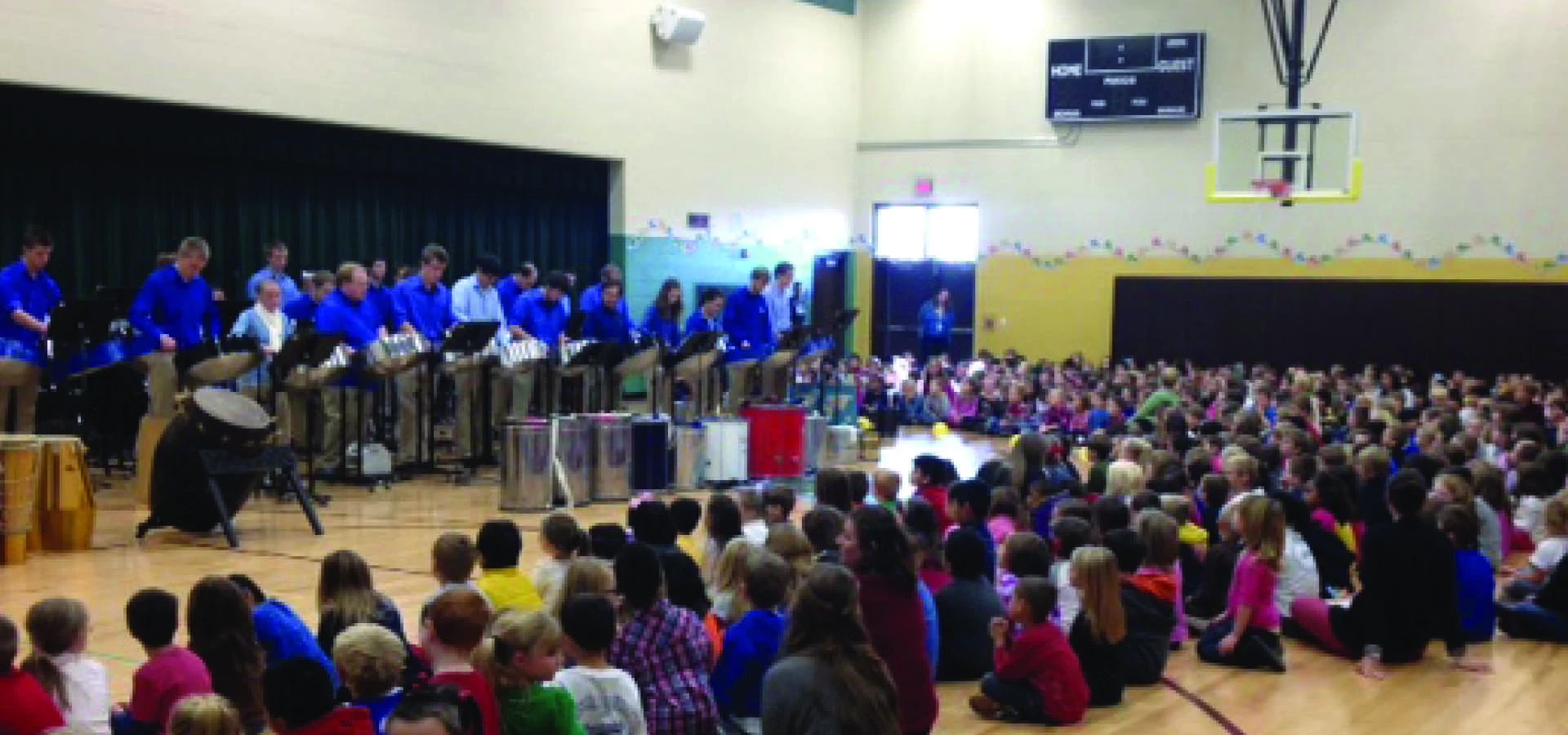 percussion students perform at elementary school gymnasium