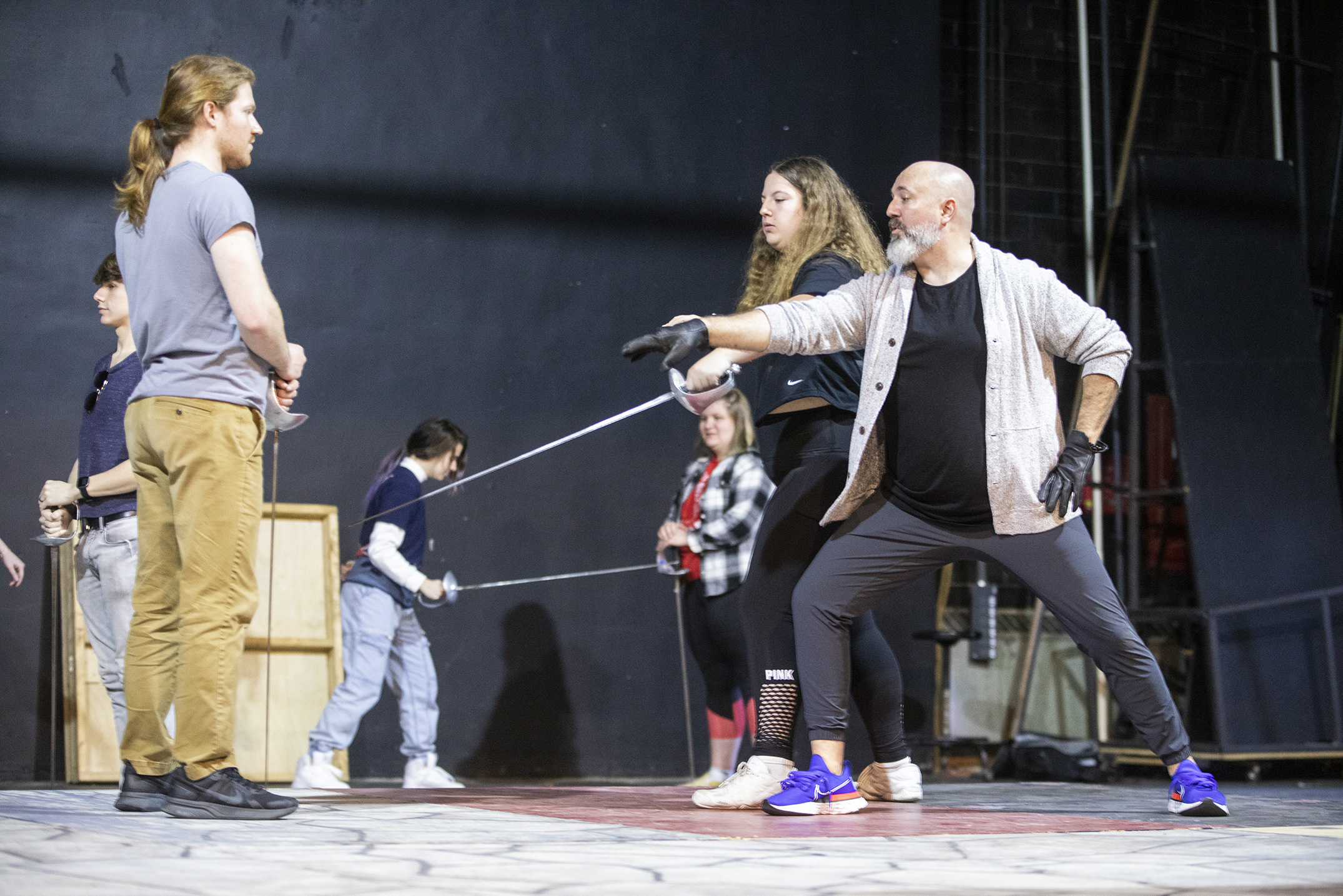 person holding sword on stage