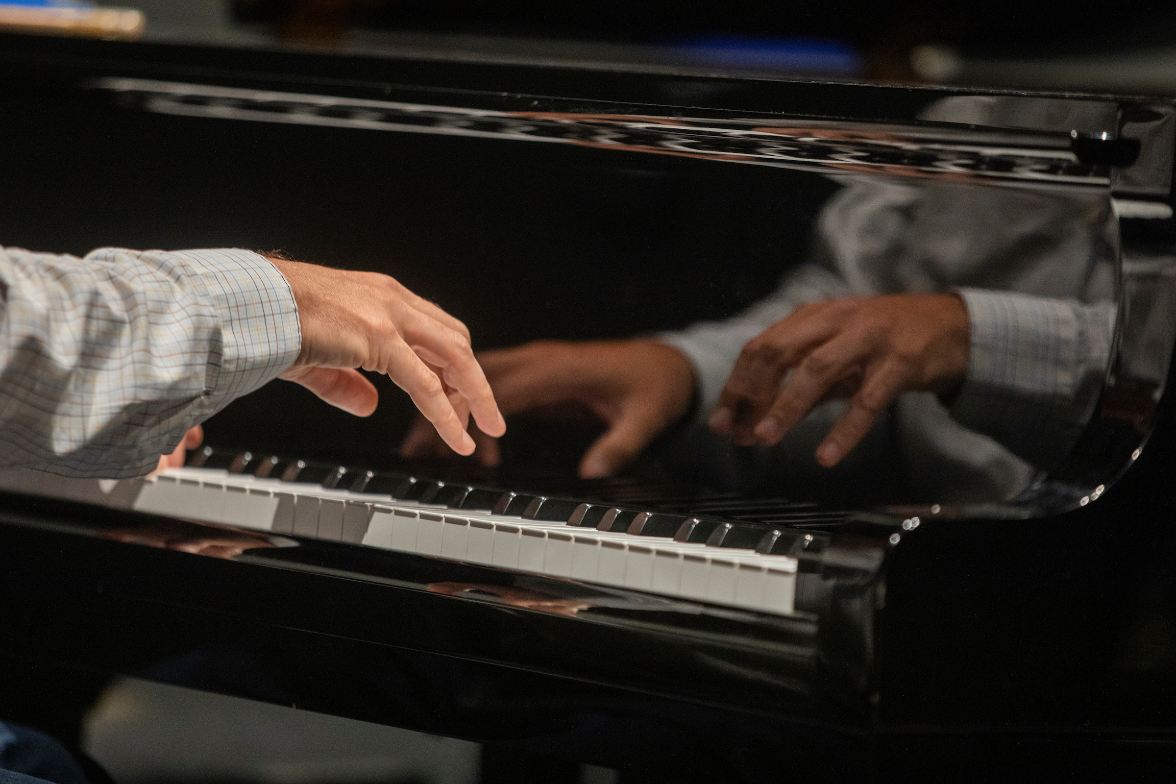 close up of hands on piano