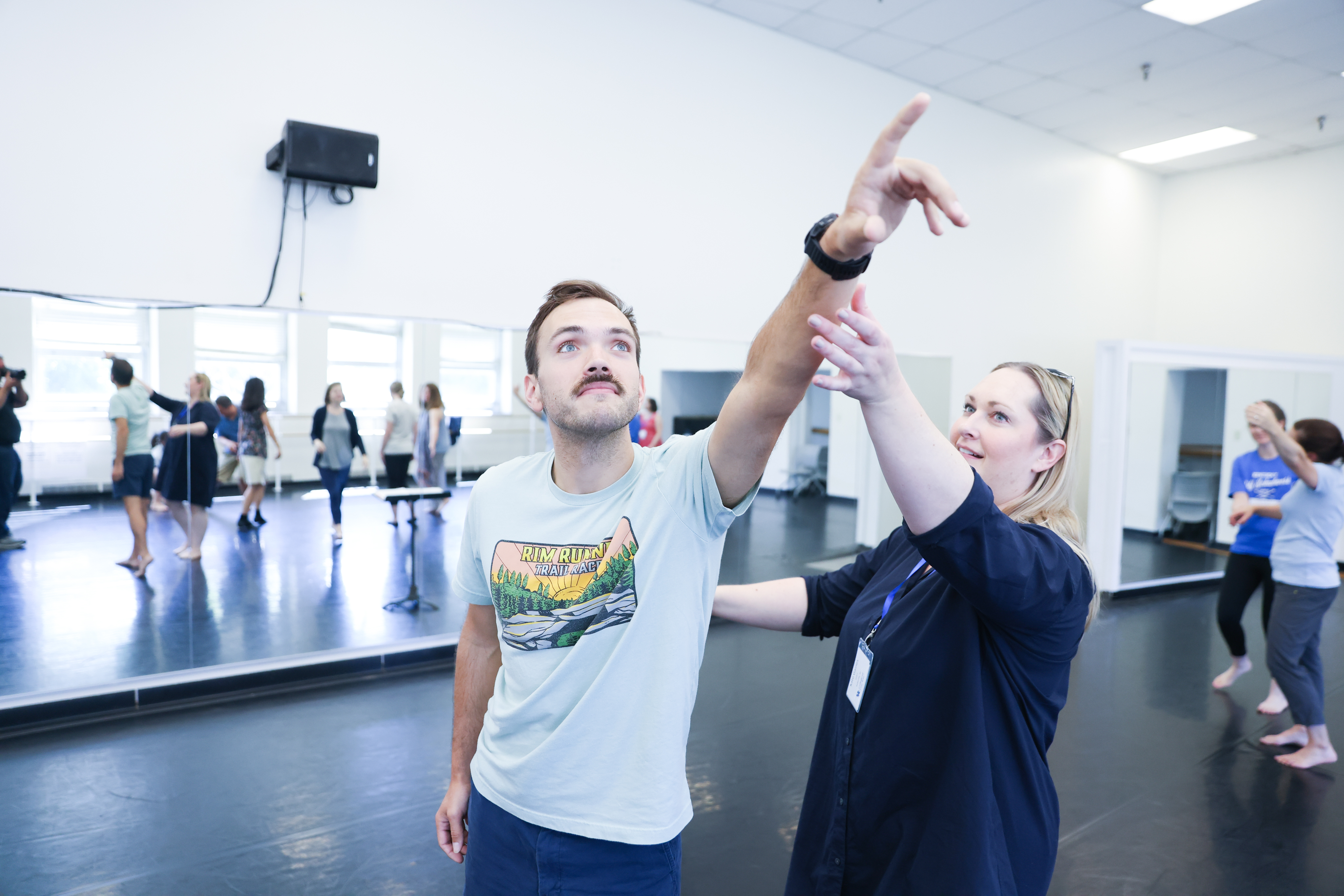 person holding someone's hand into point reaching up