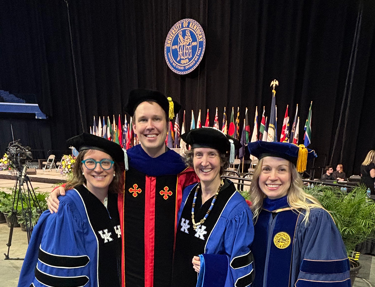 people in doctoral robes at commencement ceremony