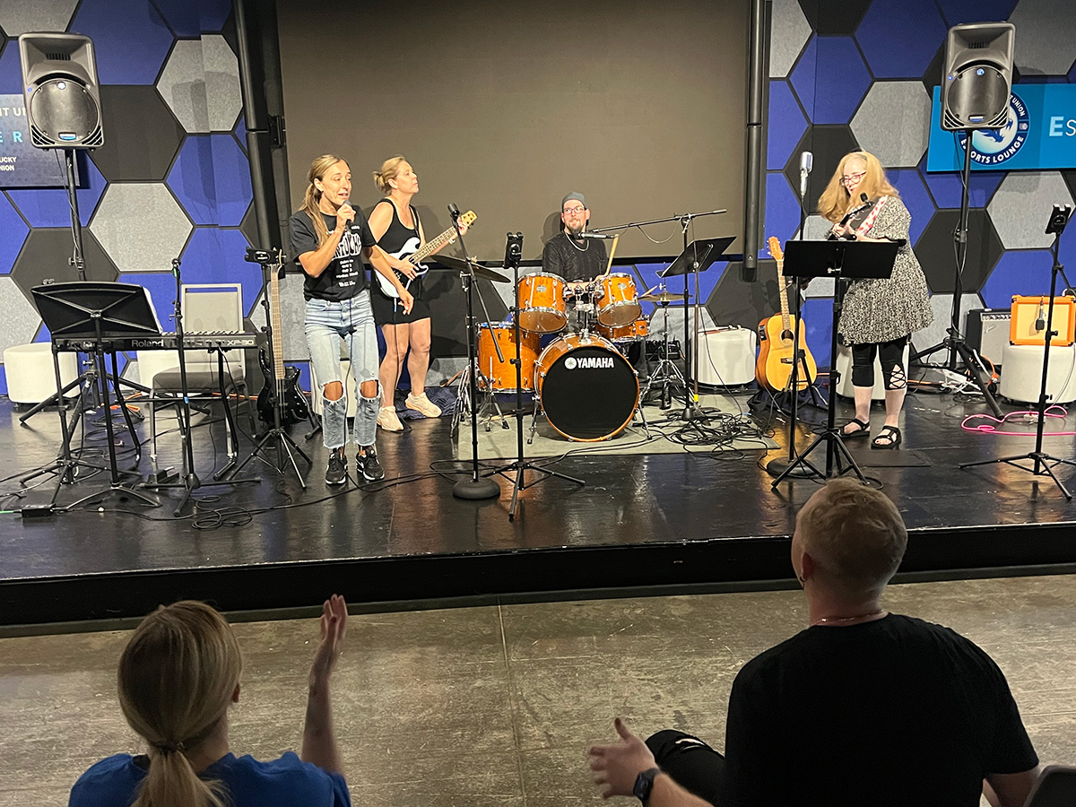 people on stage playing instruments in band