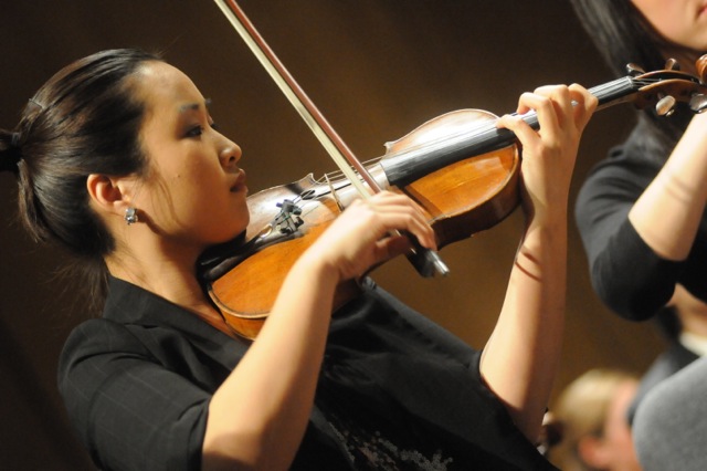 student playing violin in profile