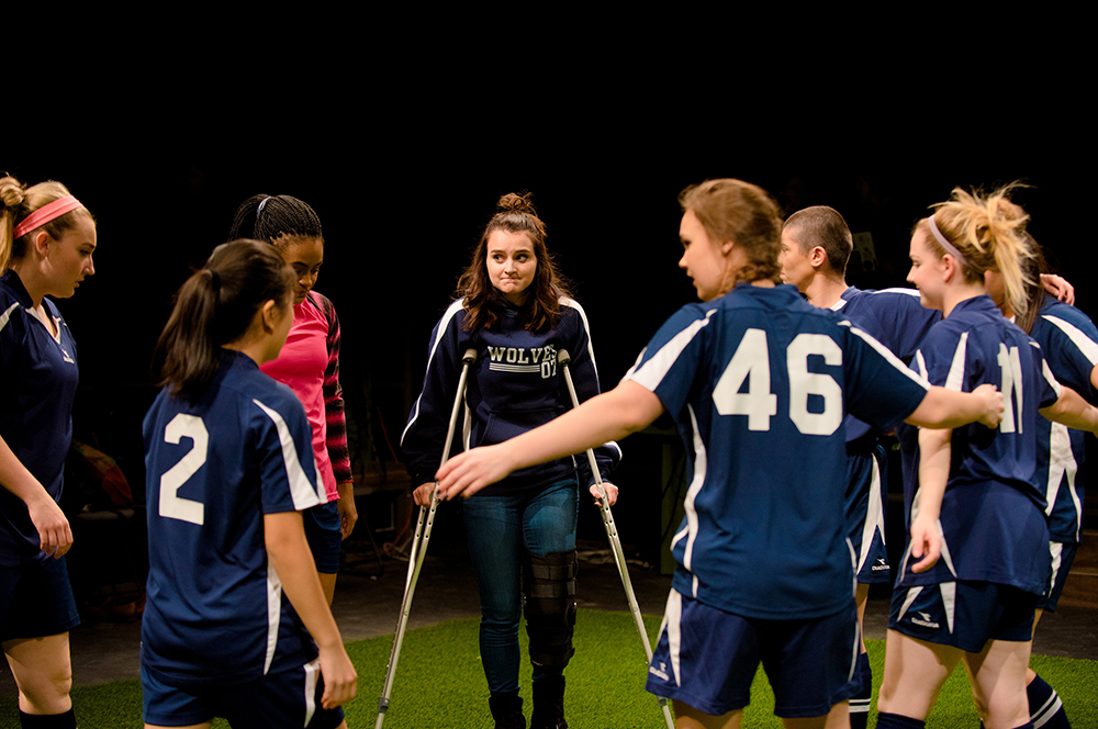 Group of students in circle wearing soccer uniforms