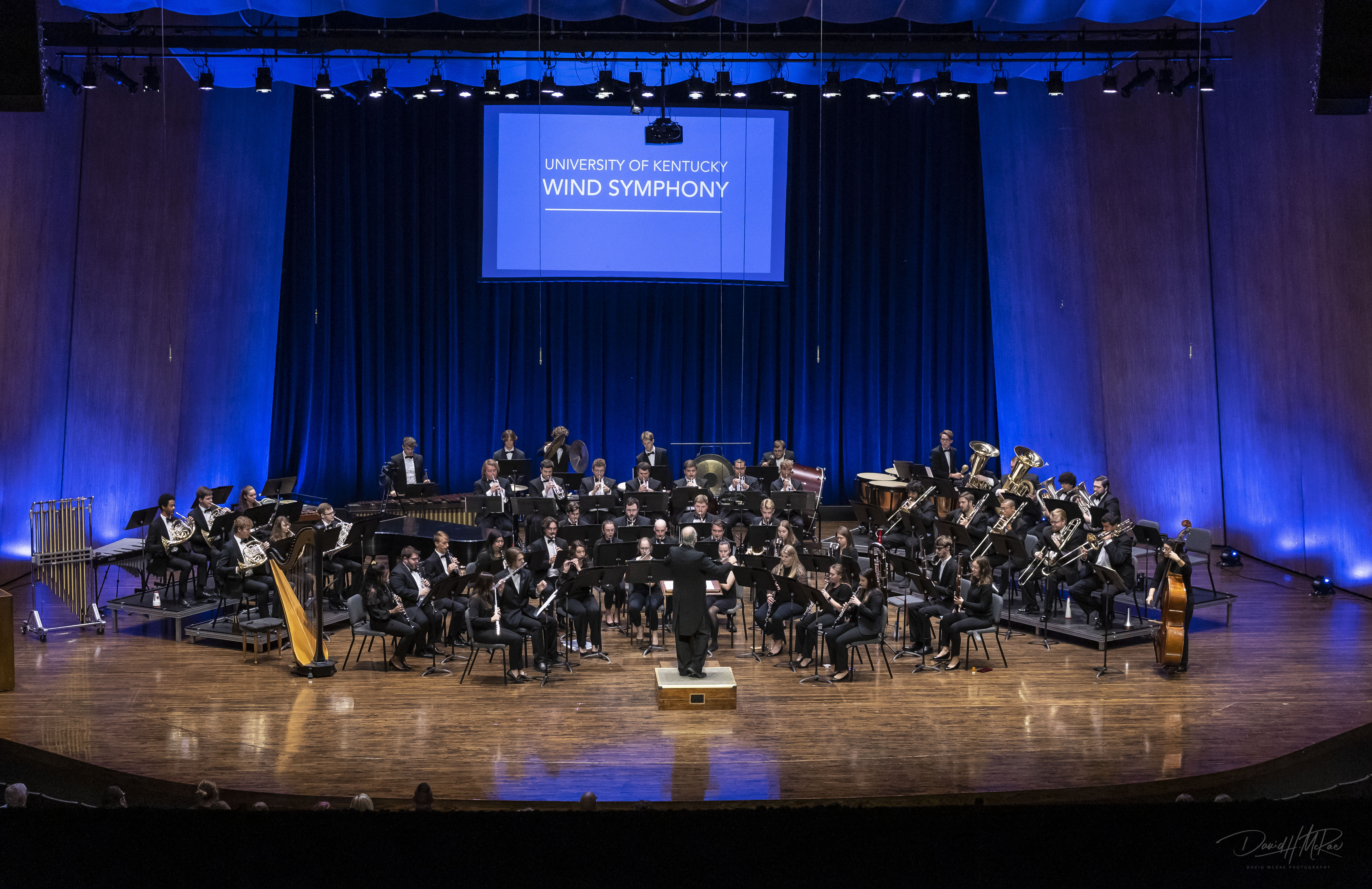Photograph of the UK Wind Symphony performing onstage at the Singletary Center 