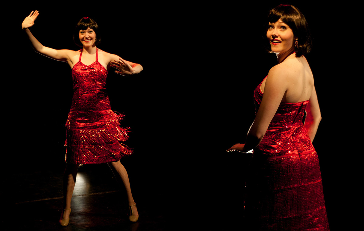 Two images of the same woman side by side standing in a spotlight in a dark theatre. She wears a bright red flapper dress with layers of beaded tassels, fishnet stockings, and yellow pumps.