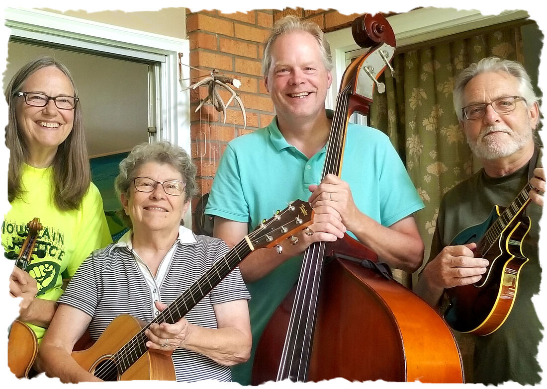TDH4 members gathered on a home porch with their instruments smiling into the camera. From left to right: Karen Jones on fiddle, Bev Futrell on guitar, Nathan Wilson on bass, and George Neel on mandolin.