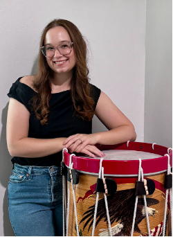 Portrait of Samantha Vivian with a large drum.
