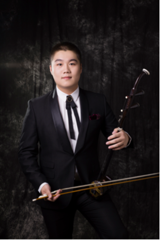 Standing portrait of Zicheng Shao holding a traditional chinese instrument.