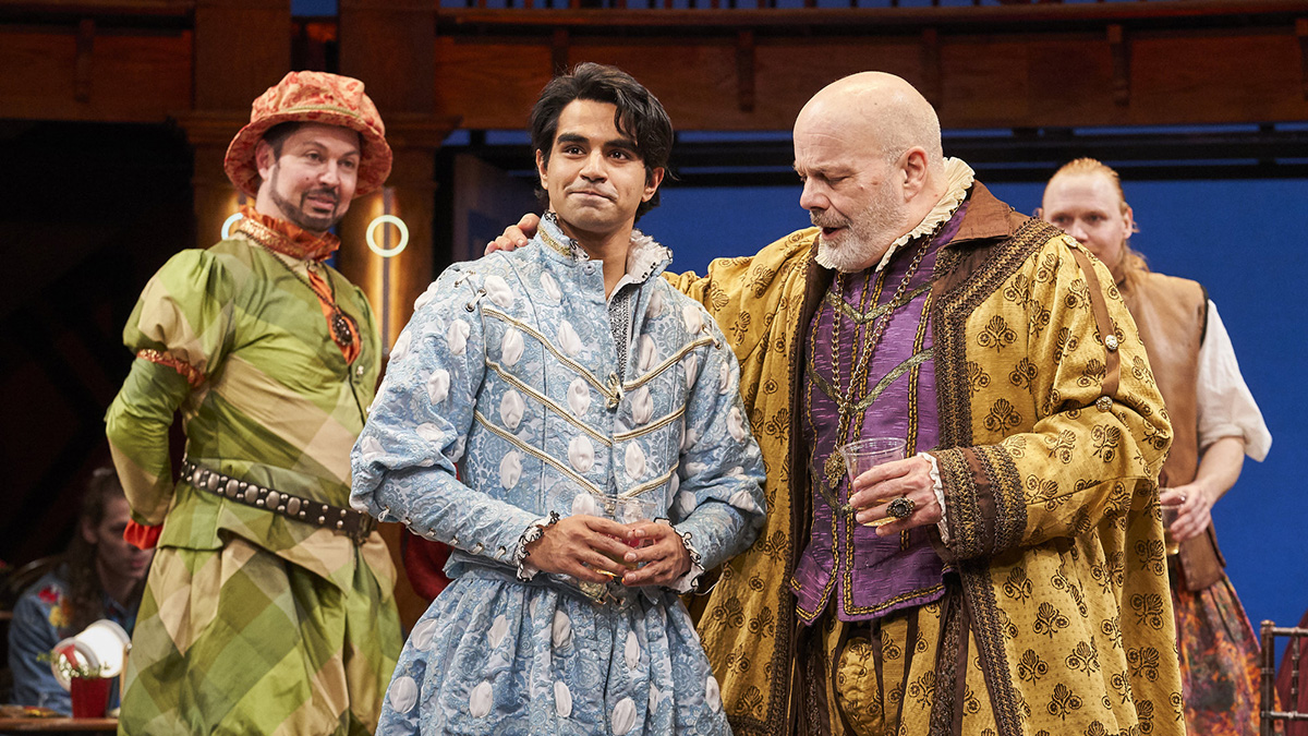 Image of Taha Mandviwala onstage with two other actors dressed in Shakespearean costumes.