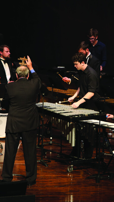 percussion musicians on stage with xylophone