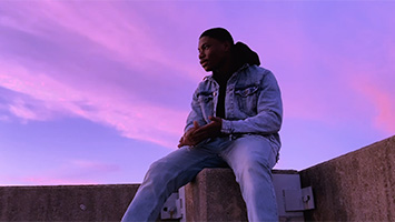 person sitting with purple sky background