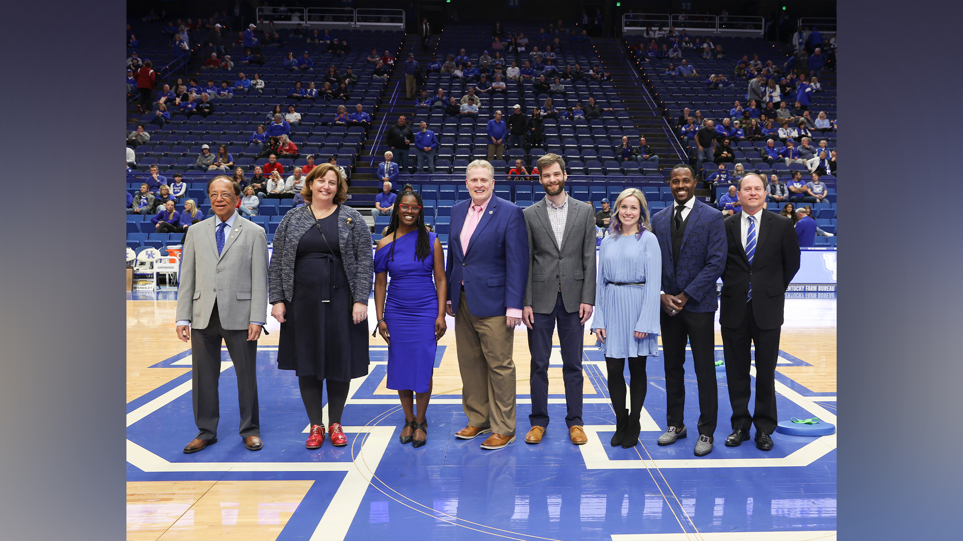 Image of 2023 Great Teachers recipients standing in the middle of the basketball court at Rupp Arena