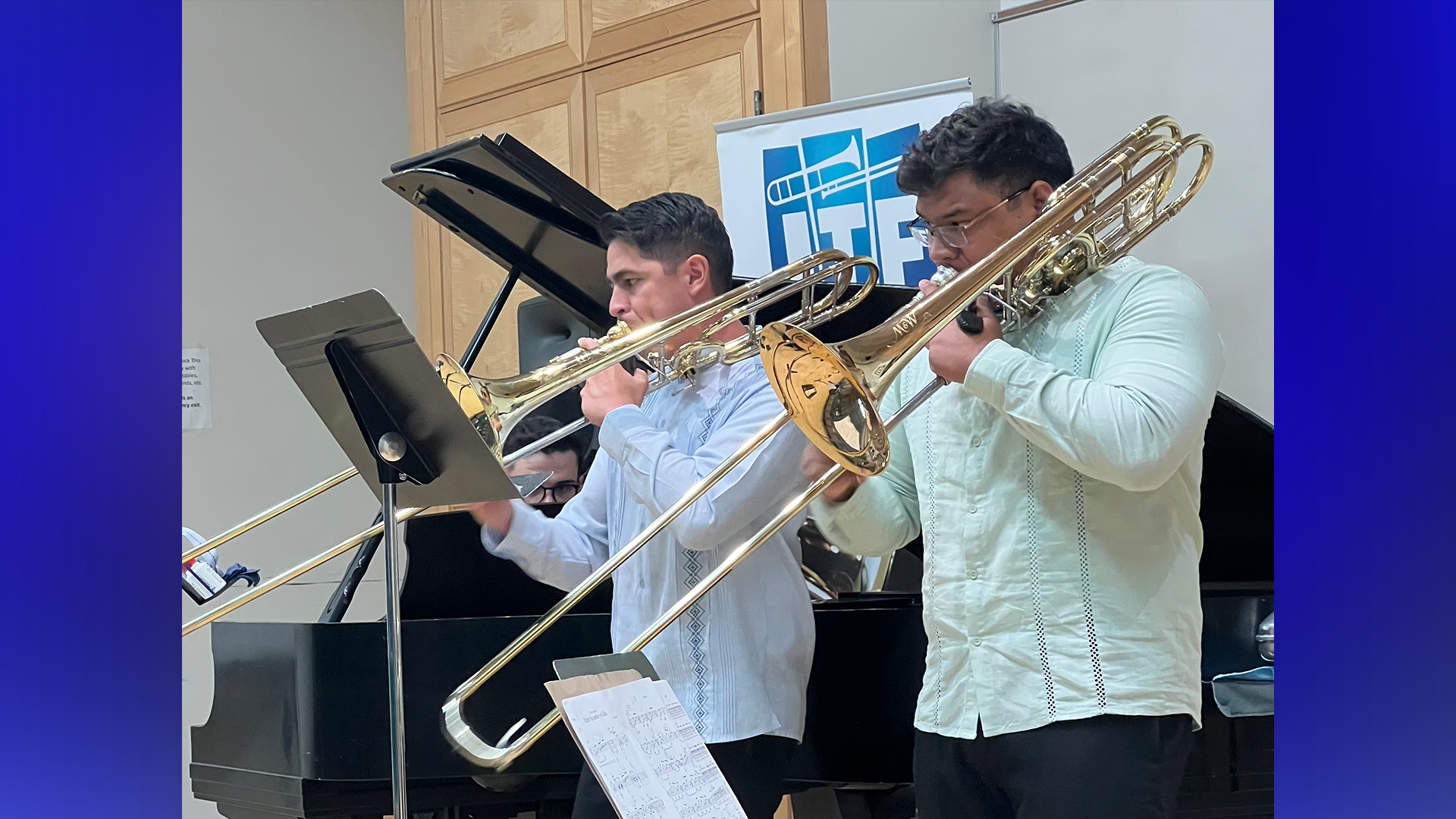 Image of Juan Saldivar, Jr. and Alex Lopez Velarde playing trombones