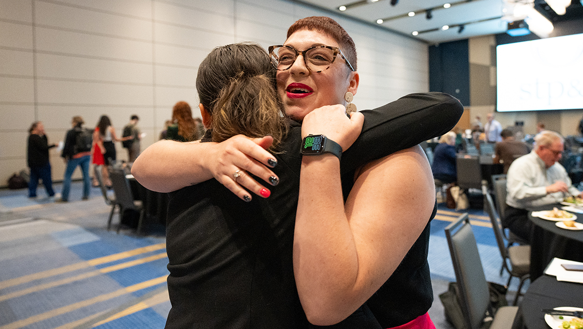 UK doctoral graduate Rebecca Ferrell is congratulated by Kaitlyn Hardiman, a current arts administration Ph.D. candidate, at the Social Theory, Politics, and the Arts symposium last September. Photo provided by Rachel Shane.