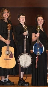 Image of Berea College Bluegrass Ensemble onstage wearing concert blacks holding their instruments