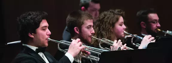 students playing instruments on stage