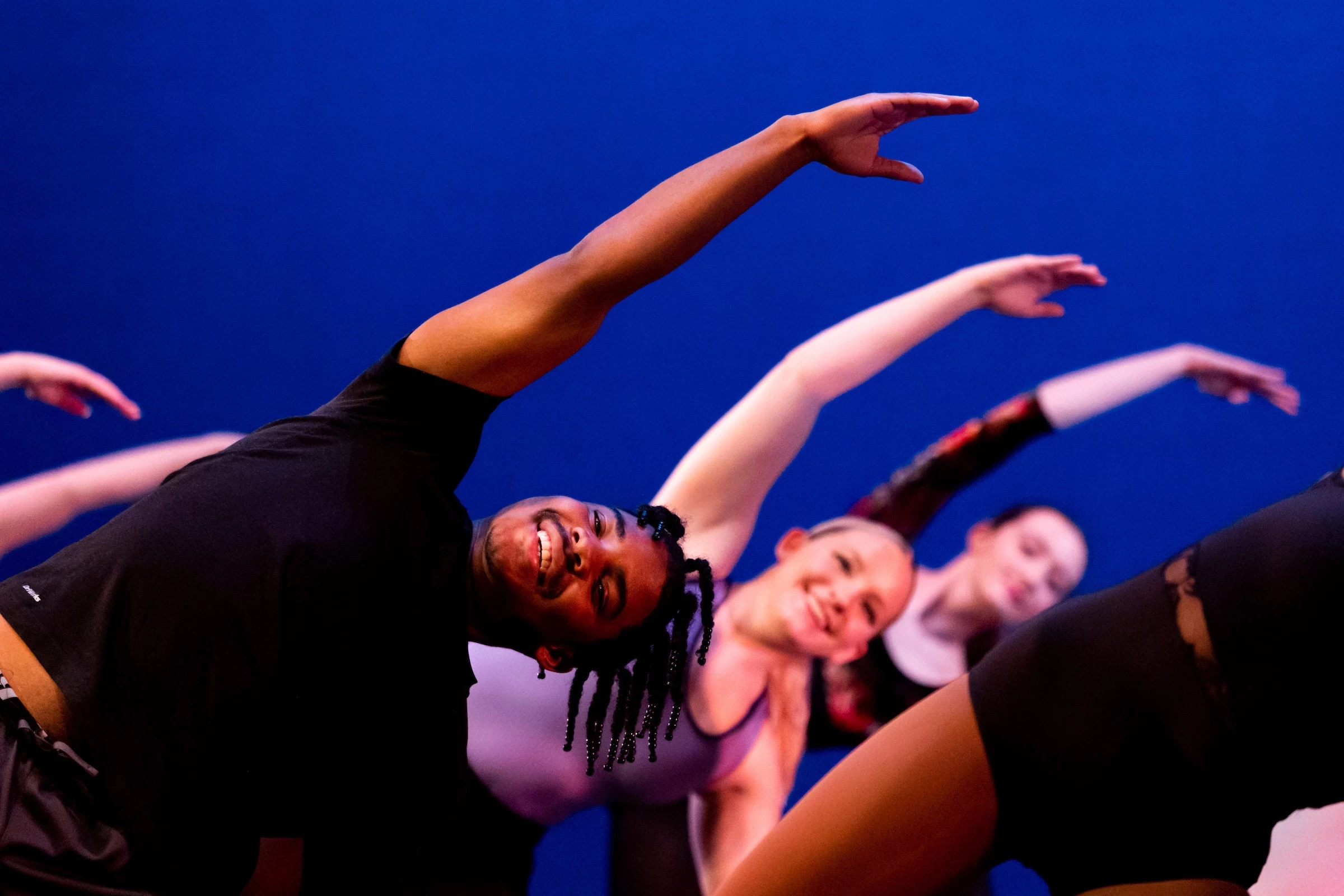 Dance students leaning over in pose.