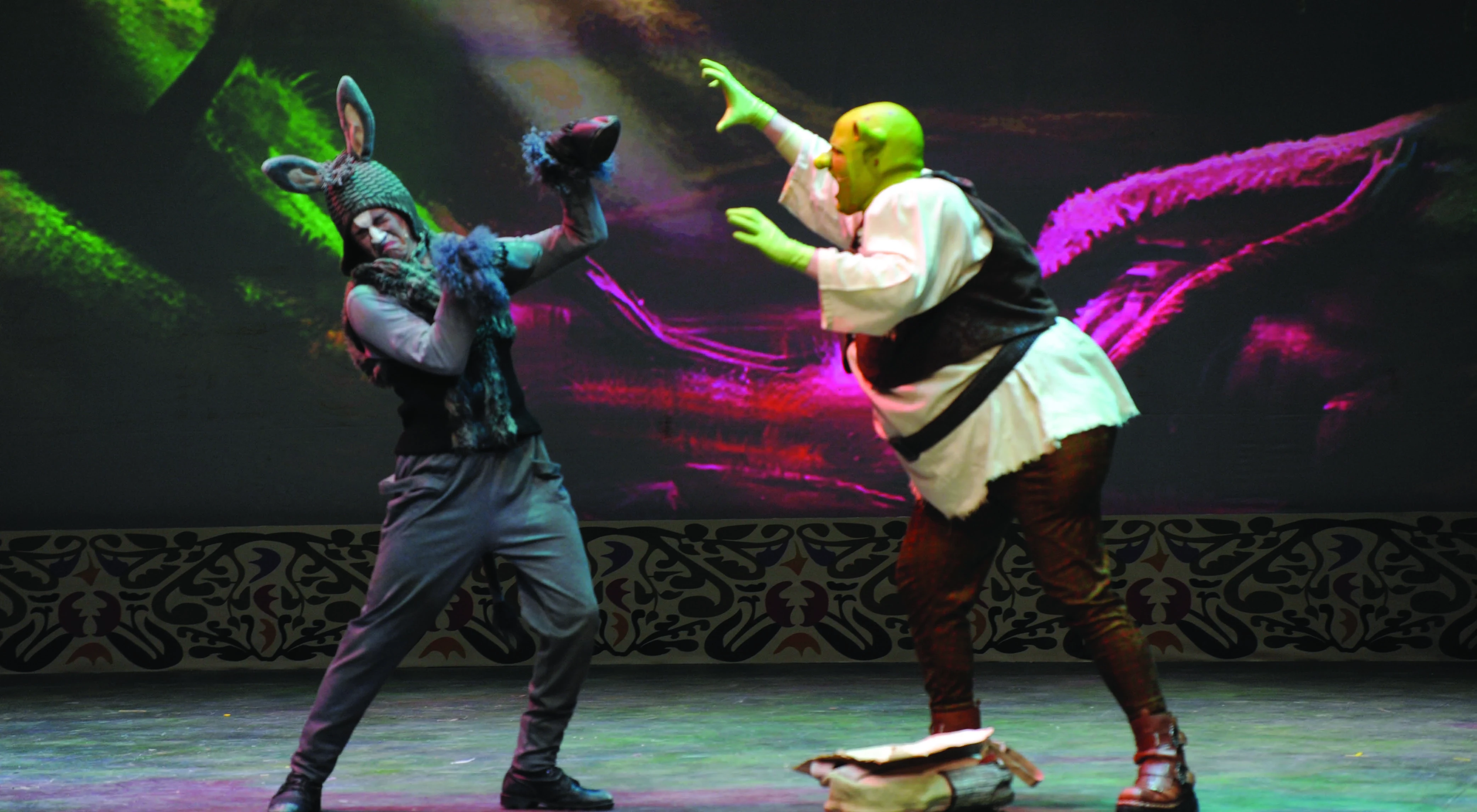 two actors on stage in costume