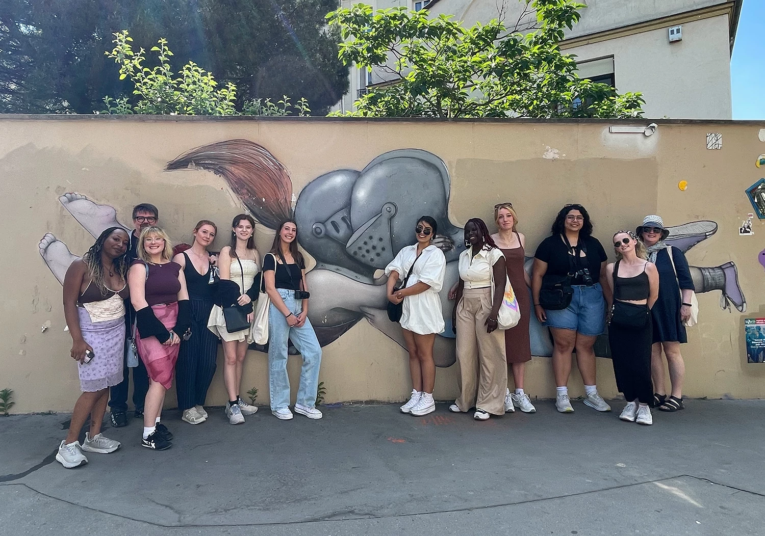 students in paris, france, in front of wall art, decorative only