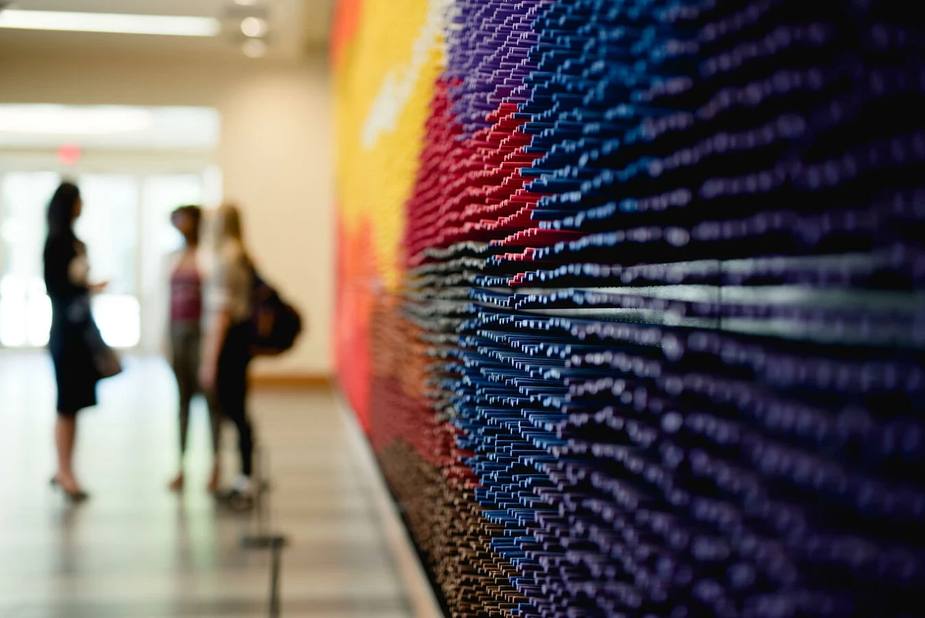 Image of students in background of hallway