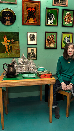 person sitting in green room in front of art