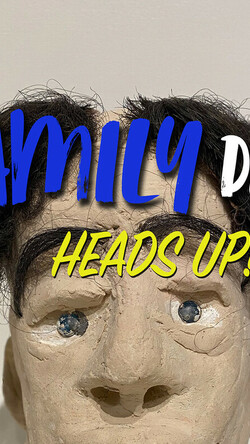Sculpture of head with text Family Day Heads Up