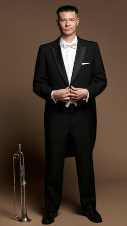 Image of Josh Cohen in tuxedo with trumpet 