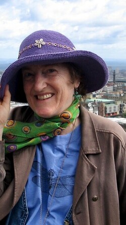 Image of Dianne Dugaw wearing a purple hat outdoors.
