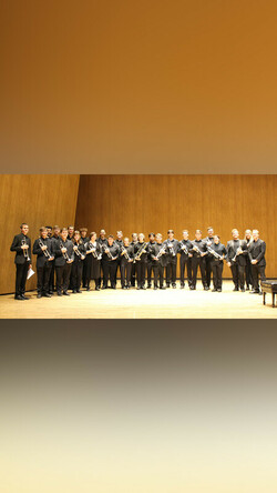 Members of UK Trumpet Ensembles onstage at the Singletary Center wearing black clothing holding their trumpets