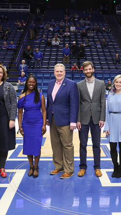 Image of 2023 Great Teachers recipients standing in the middle of the basketball court at Rupp Arena