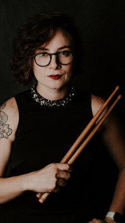 Image of Emily Durocher holding drum mallets 