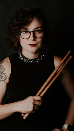 Image of Emily Durocher holding drum mallets