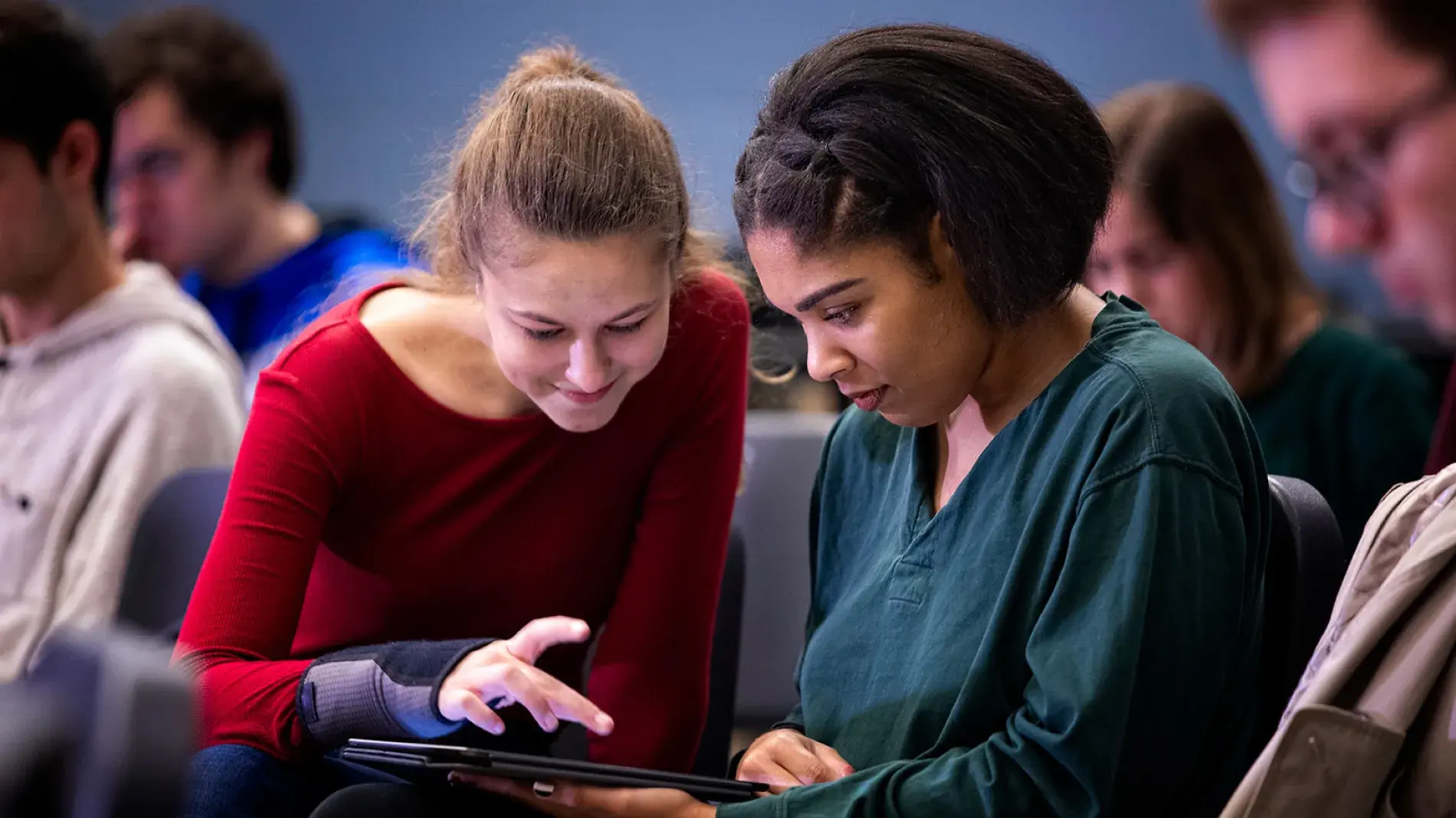 two students looking at ipad