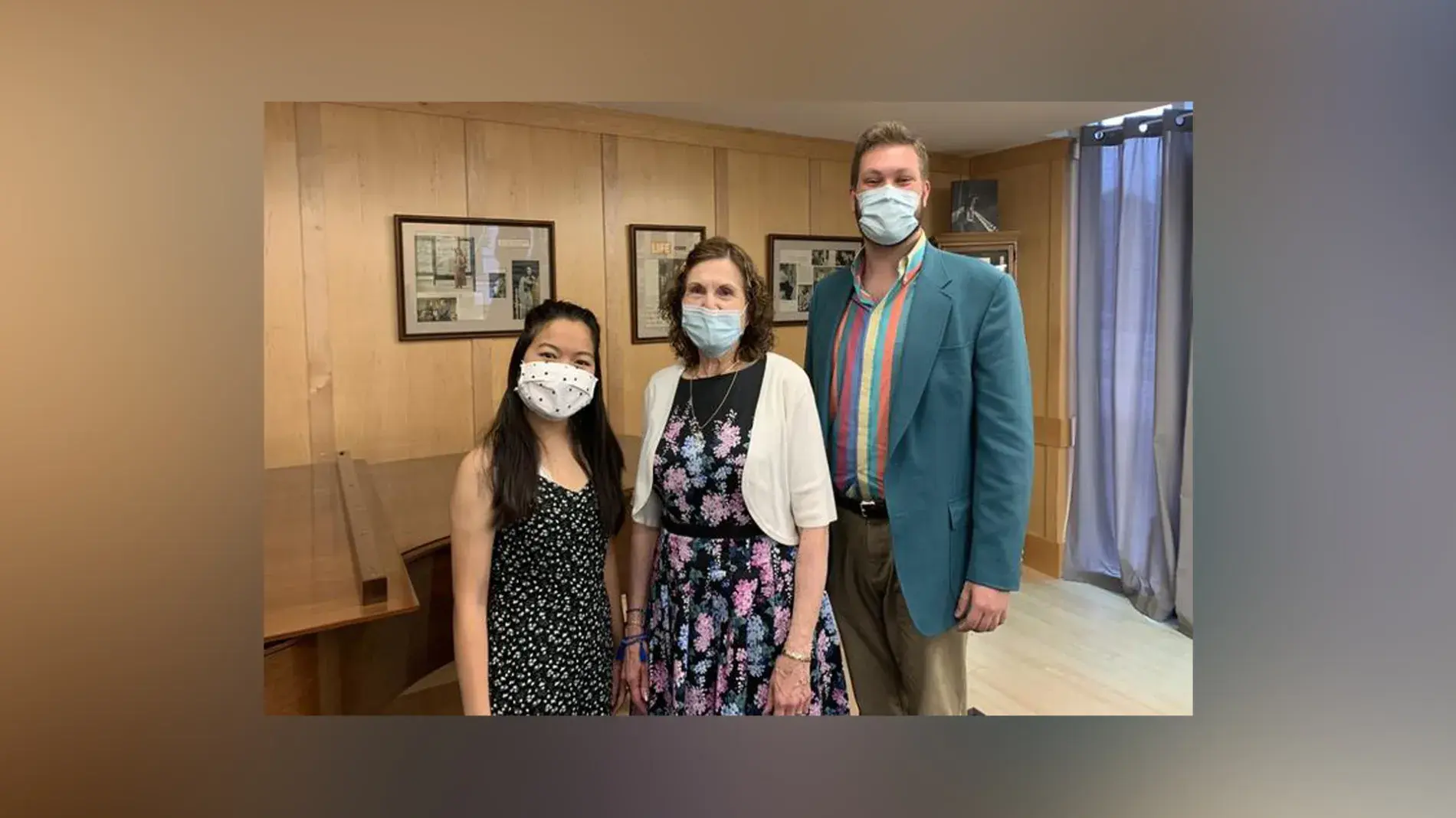 Image of three people wearing face masks posing inside a music studio