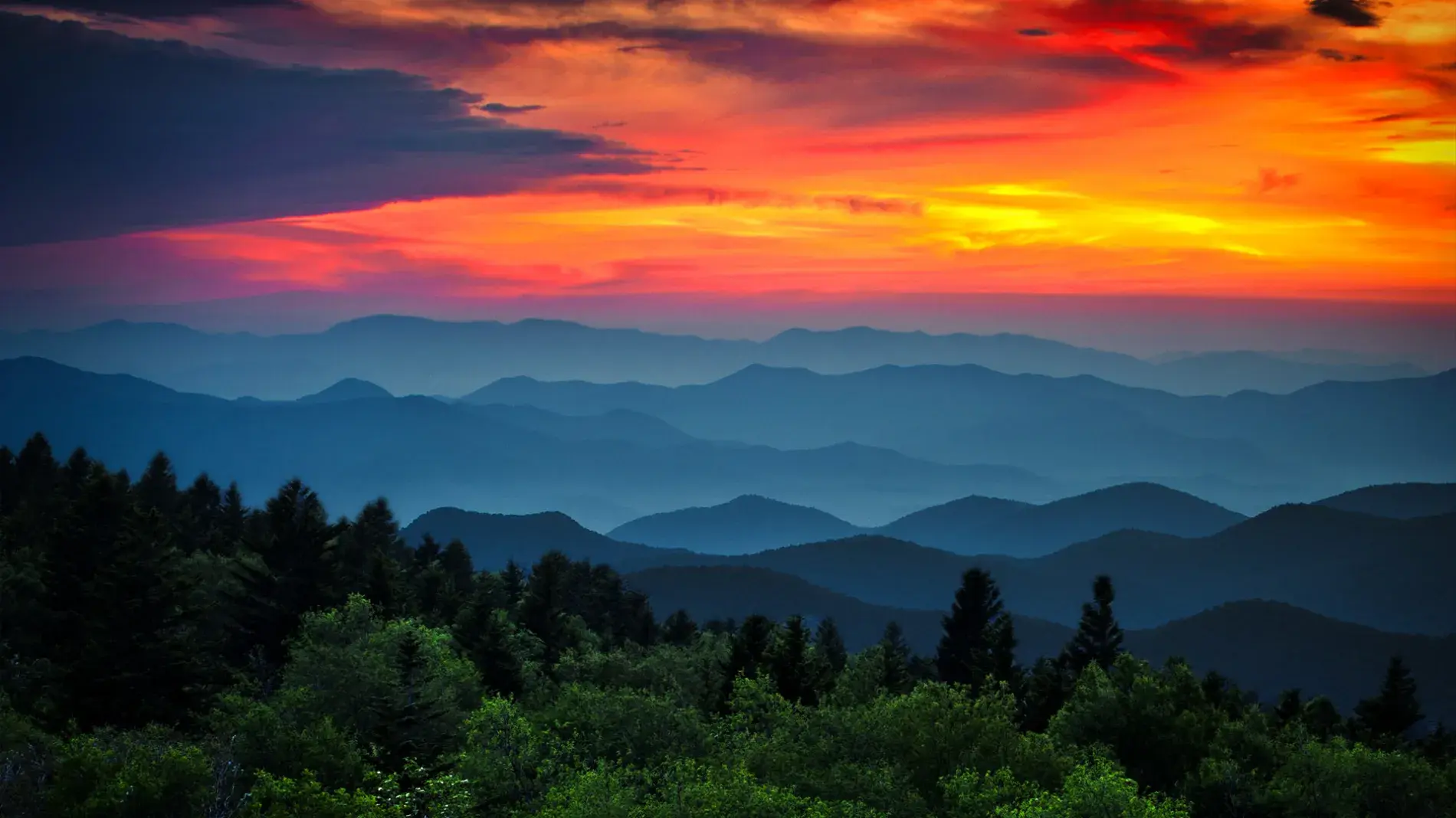 Digitally enhanced image of a sunset sky and mountains in the foreground