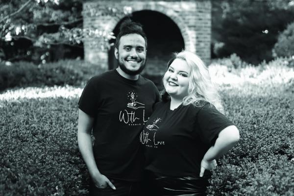 Tommy Townsend and Alexandra Burns post together wearing tshirts with the With Love business logo, black and white photo