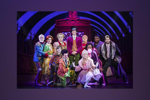 Production still of Charle and the Chocolate Factory with cast onstage posed in bright costumes