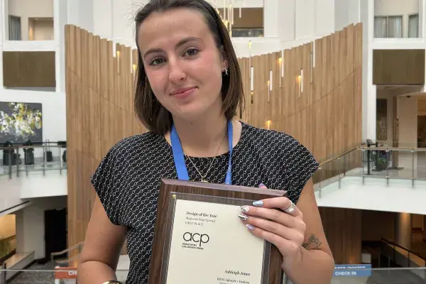 Image of Ashleigh Jones holding her awards inside a hotel at the MediaFest 2025