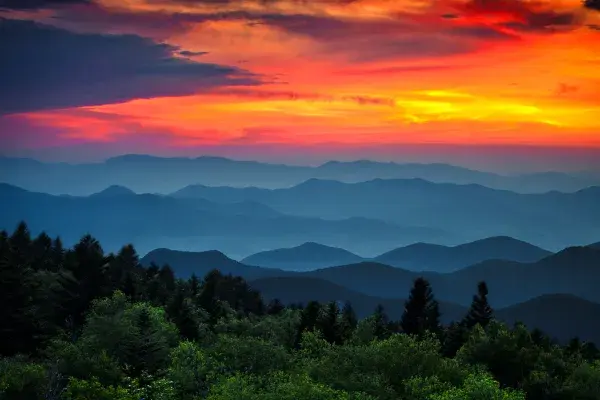 Digitally enhanced image of a sunset sky and mountains in the foreground