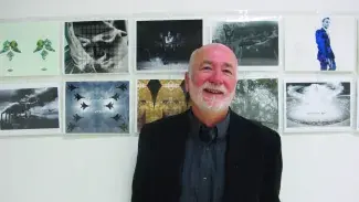 Michael Braun on wall with art