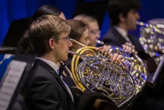 person playing french horn
