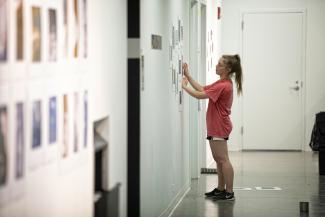 student hanging art