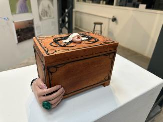 wooden box with hand sculpted on side