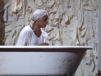 person in bathtub on stage