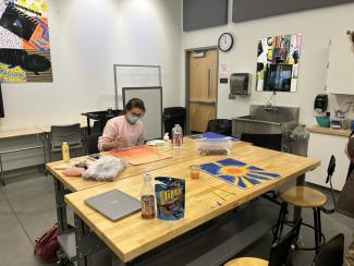 student at table working on crafts