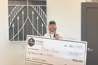 Mitchell Burleson holds giant check