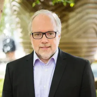 Headshot of Dr. Kevin Murphy wearing glasses, black blazer and dress shirt.