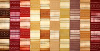 warm reds, oranges, golds, and brown in woven pattern art by Catherine Ellis